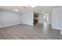 Open living room featuring neutral walls, recessed lighting, and modern gray wood-look flooring at 5027 Overton Dr, New Port Richey, FL 34652