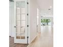 Bright hallway with tiled floors, glass-paned doors, and views to the backyard at 511 Roanoke St, Dunedin, FL 34698