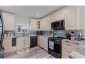 Well-lit kitchen showcasing stainless steel appliances, granite counters and decorative backsplash at 5201 108Th N St, St Petersburg, FL 33708