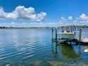 Beautiful waterfront view of the boat dock with a boat, against a backdrop of a serene waterway at 5225 Brighton Shore Dr, Apollo Beach, FL 33572