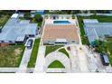 This property boasts a private pool, well-manicured lawn, and circular driveway, creating an inviting outdoor space at 5672 62Nd N Way, St Petersburg, FL 33709
