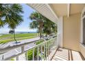 Private balcony featuring views of the Gulf, beautiful foliage, and scenic beauty at 611 Destiny Dr # 204, Ruskin, FL 33570