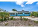 A cozy single-story home with a light blue exterior and lush front yard plants at 6132 7Th S Ave, Gulfport, FL 33707
