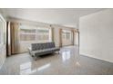 Bright living room featuring terrazzo floors, neutral walls, and a gray sofa at 6132 7Th S Ave, Gulfport, FL 33707