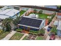 Aerial view of the home with solar panels, backyard deck and fire pit at 6183 5Th S Ave, St Petersburg, FL 33707