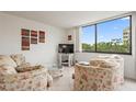 Bright living room with large windows offering scenic views and comfortable seating, perfect for relaxation at 6269 Palma Del Mar S Blvd # 306, St Petersburg, FL 33715