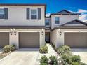 Well-maintained townhome with attached garages and professionally landscaped front yard at 841 Royal Empress Dr, Ruskin, FL 33570