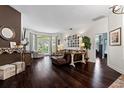 Bright and airy living room showcasing hardwood floors and access to the outdoors through glass doors at 9075 Waterash N Ln, Pinellas Park, FL 33782