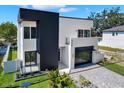 Striking home exterior with modern design, clean lines, large windows, and a well-kept lawn at 908 W Fribley St, Tampa, FL 33603
