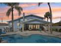 Gorgeous outdoor space with covered patio seating, outdoor furniture, and a stunning in ground swimming pool at 931 Gulf Blvd, Belleair Beach, FL 33786