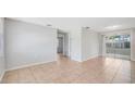 Open living room area with neutral paint, tile flooring, and sliding glass doors to an enclosed patio at 10184 117Th Dr, Largo, FL 33773
