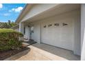 Attached one car garage featuring a door with decorative windows and a well-manicured lawn at 11698 75Th Ave, Seminole, FL 33772