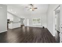 Open-concept living room featuring dark hardwood floors and vaulted ceilings at 13227 Quigley Ave, Weeki Wachee, FL 34614