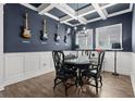 Dining room showcases blue walls, detailed trim work, and guitars mounted on the wall at 14855 Renaissance Ave, Odessa, FL 33556