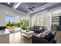 Spacious living room featuring hardwood floors, natural light, and access to a patio at 14855 Renaissance Ave, Odessa, FL 33556