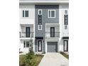 Modern townhome showcases a stylish facade with a private balcony and attached garage at 1529 N Morgan St, Tampa, FL 33602
