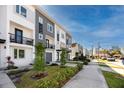 View of modern townhomes along a sidewalk, with downtown in the distance at 1529 N Morgan St, Tampa, FL 33602