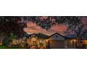 Charming single-story home with a well-manicured lawn, mature trees, and inviting curb appeal during a beautiful sunset at 15934 Sorawater Dr, Lithia, FL 33547