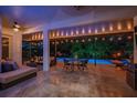 Relaxing outdoor living space with a covered patio, string lights, and a view of the sparkling pool at 15934 Sorawater Dr, Lithia, FL 33547