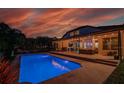 Stunning backyard oasis with a sparkling pool, covered patio, and ample seating for outdoor entertaining at 15934 Sorawater Dr, Lithia, FL 33547