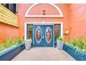 Charming exterior features a unique door and manicured potted plants at 215 Central Ave # 2B, St Petersburg, FL 33701