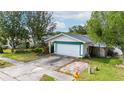 Charming single Gathering home with a two car garage, mature trees, and manicured landscaping at 21608 Wytheville Way, Lutz, FL 33549