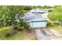 Charming single Gathering home with a two car garage, mature trees, and manicured landscaping at 21608 Wytheville Way, Lutz, FL 33549