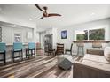 Open-concept living room with modern furnishings, wood-look floors, and great natural light at 2479 Trade Winds Dr, Dunedin, FL 34698