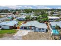 Aerial view of single-story home with neat landscaping, carport, and neighborhood setting at 323 48Th Nw St, Bradenton, FL 34209