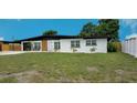 Single-story home boasts a sleek black roof, freshly painted white exterior, and newly installed front yard at 323 48Th Nw St, Bradenton, FL 34209
