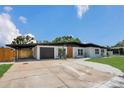 A single-story home features a carport, garage, and well-kept landscaping at 323 48Th Nw St, Bradenton, FL 34209