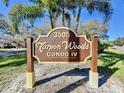 Tarpon Woods Condo IV community sign surrounded by palm trees and blue skies at 3505 Tarpon Woods Blvd # I407, Palm Harbor, FL 34685