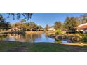 Scenic view of a tranquil pond surrounded by lush greenery and residential buildings at 3505 Tarpon Woods Blvd # I407, Palm Harbor, FL 34685