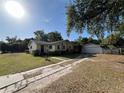 Charming single-story home featuring a detached garage and a long driveway at 403 E Carolina Ave, Plant City, FL 33563