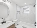 Elegant bathroom featuring marble tile, modern fixtures, and a sleek vanity at 4215 E Paris St, Tampa, FL 33610