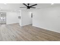 Spacious living room with new laminate floors, recessed lighting, and fresh paint at 4215 E Paris St, Tampa, FL 33610