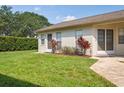 Well-kept backyard featuring lush lawn, mature trees, and partial view of the home's exterior at 4655 Wallingford Ct # 4655, New Port Richey, FL 34655