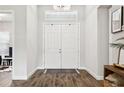 Bright foyer featuring beautiful wood floors, an elegant chandelier, and a view of the home's stylish interior at 5314 Alafia Falls Dr, Lithia, FL 33547