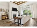Cozy living room with a fireplace, large windows, and comfortable seating creating a relaxing ambiance at 5314 Alafia Falls Dr, Lithia, FL 33547