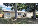 Charming single story home with neutral paint, white shutters, landscaping and attached garage at 6067 43Rd N Ter, Kenneth City, FL 33709