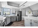 Bright kitchen with stainless steel refrigerator, gray cabinets, and view of breakfast nook at 609 Lively Dr # B, Sun City Center, FL 33573