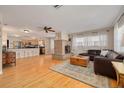 Open-concept living room with hardwood floors, a brick fireplace, and seamless access to the kitchen at 6114 7Th S Ave, Gulfport, FL 33707
