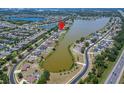 Aerial view of the property with beautiful landscaping and lakefront with neighborhood at 6425 Clair Shore Dr, Apollo Beach, FL 33572