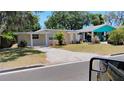 Inviting single-story home with well-maintained lawn and charming curb appeal on a sunny day at 6434 Old Main St, New Port Richey, FL 34653