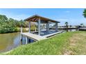Image of a boat dock with a covered lift on a waterway at 6522 Simone Shores Cir, Apollo Beach, FL 33572