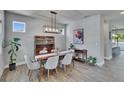 Elegant dining room with stylish light fixture, wood floors, and modern decor at 7203 1/2 S West Shore Blvd, Tampa, FL 33616