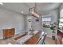 Bright dining room featuring modern light fixture, wood table, and a view to the exterior at 7203 1/2 S West Shore Blvd, Tampa, FL 33616