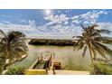 Breathtaking waterfront view with a private dock and a boat at 803 Harbor Dr, Belleair Beach, FL 33786