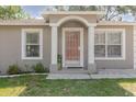 Charming home with a covered front porch and decorative security door at 8517 N Branch Ave, Tampa, FL 33604