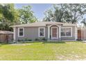 Charming single-story home with a well-maintained front yard and fresh landscaping at 8517 N Branch Ave, Tampa, FL 33604